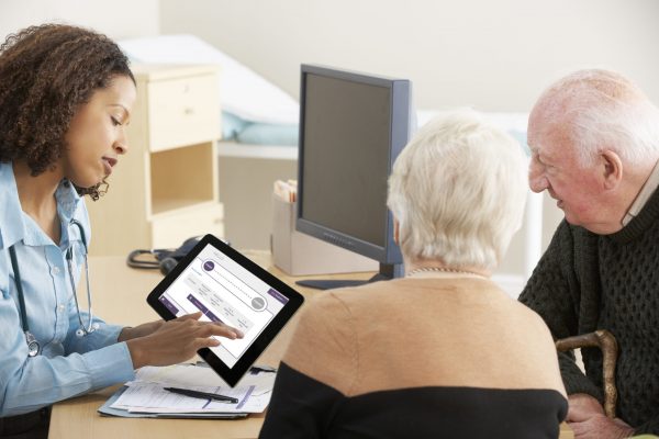 Young female Doctor talking to senior couple Young female Doctor talking to senior couple